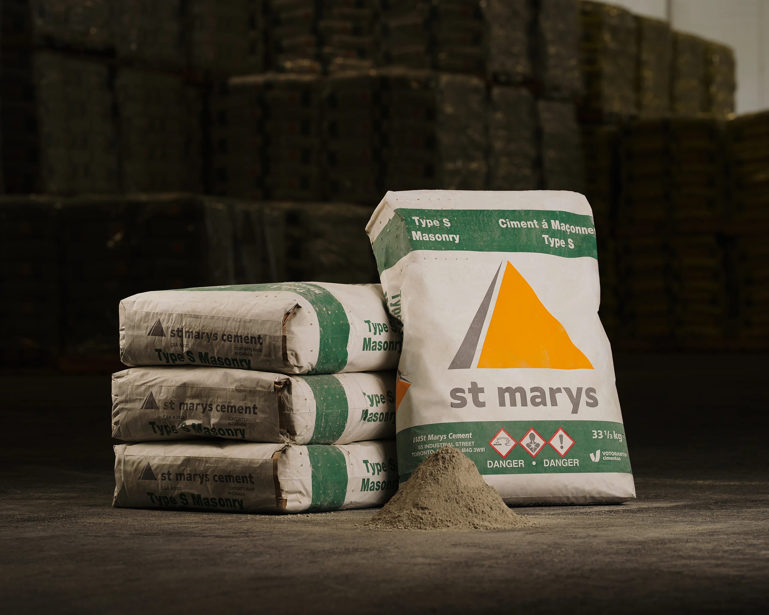 Type S Masonry Cement - white and green St Marys bags stacked beside a pile of cement powder